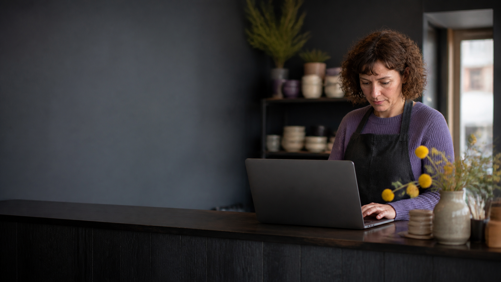 A small-business owner looking at a website on a laptop